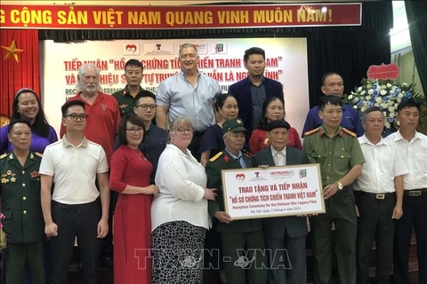 War evidence records of Vietnamese soldiers who laid down their lives or were missing in the resistance war against the US imperialists are handed over to their families at a ceremony in Hanoi. (Photo: VNA)