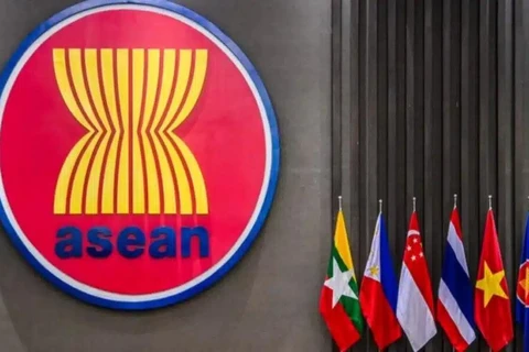 The ASEAN logo seen outside a building next to the flags of some of its members, in this file photo. — (Photo: BERNAMA)