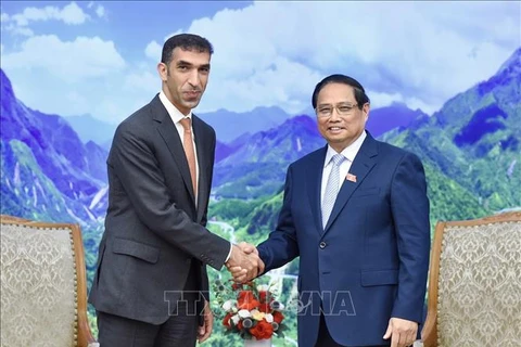 Prime Minister Pham Minh Chinh (R) and UAE Minister of State for Foreign Trade Thani bin Ahmed Al Zeyoudi, Hanoi, August 26 (VNA)