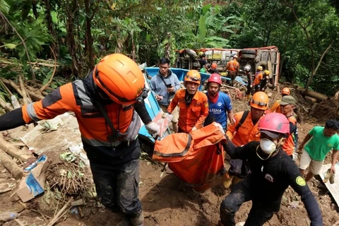 Rescuers transfer the body of a victim at the site of a landslide at Cisarakan village in Sukabumi Regency, West Java Province, Indonesia on December 7. (Photo: Xinhua)