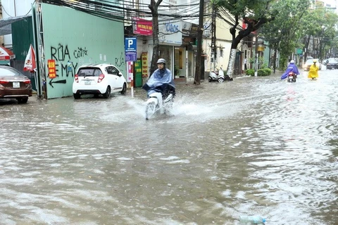 Heavy rain floods some Hanoi streets
