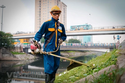 Environment workers clean up To Lich river