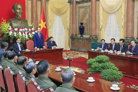 President receives Lao people with contributions to VN revolution