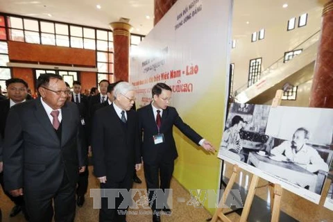 Vietnamese, Lao leaders attend exhibition on special solidarity