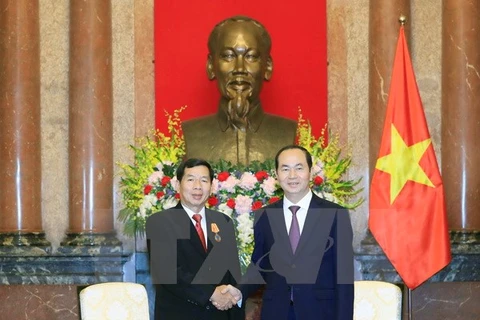 President Tran Dai Quang receives Lao supreme court chief