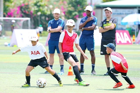 English football coaches train kids in Vietnam