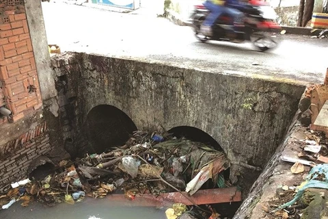Litter in canals, sewers worsens floods in HCM City
