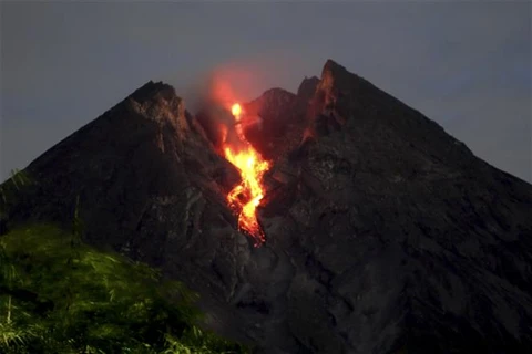 Volcanoes in Indonesia spew incandescent lava, ash column