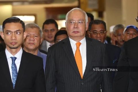 Former Malaysian PM ordered to enter defence on seven charges