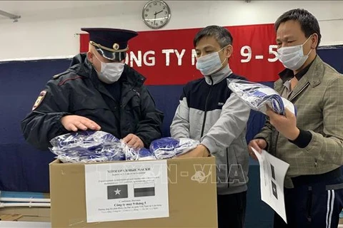 Vietnamese in Russia present masks to locals