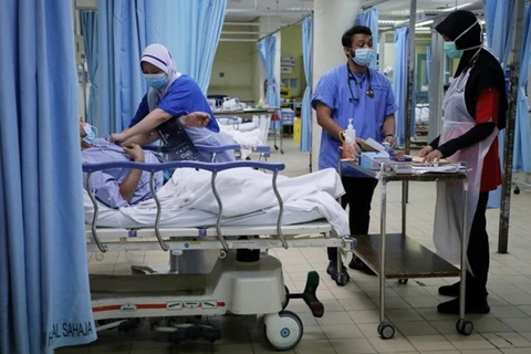 Malaysia’s healthcare system overloads as COVID-19 infections soar