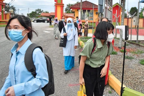 Malaysian students come back to school after six months