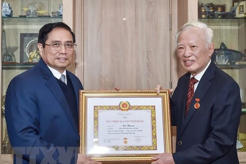 60-year Party membership badge presented to former Deputy PM