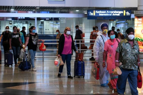Malaysia shortens quarantine period for travellers with booster shots