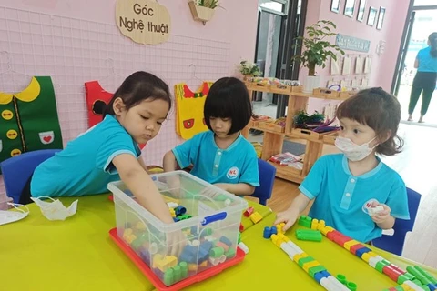 Kindergarten students in Hanoi return to school