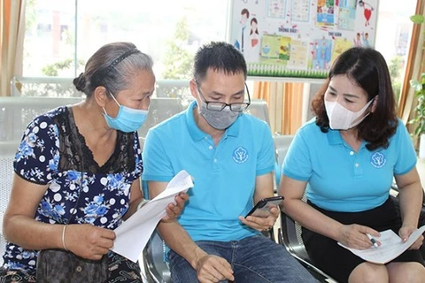 First Hanoi district to help the poor participate in voluntary social insurance