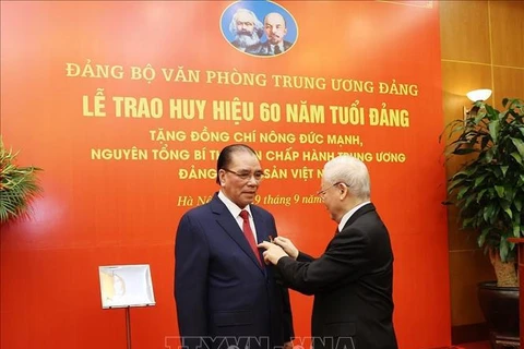 60-year Party membership badge presented to former Party chief Nong Duc Manh