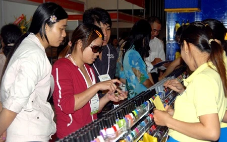 Customers buy cosmetics at a trade fair in HCM City. Viet Nam's cosmetic market is seen as having huge potential, with turnover of roughly US$704.2 million every year. (Photo: VNA/VNS)