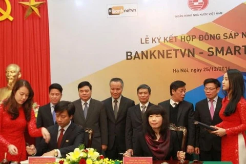 Banknetvn and Smartlink officially signed the merger contract on December 25 (Photo: VNA)