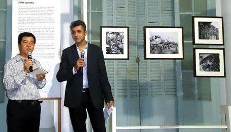 Olivier Tessier (right), director of the Ecole Francais d'Extreme Orient – EFEO, in HCM City, at the opening of an exhibition of 100 photographs chosen from over 50,000 (Photo: SunnyRose)