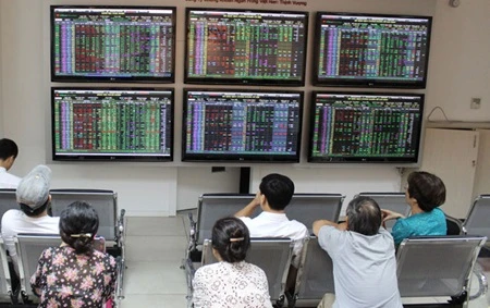 Investors watch market developments at the VP Bank Securities trading floor. Viet Nam has a population of 91 million people and a modest stock-market capitalisation of about US$46 billion, equivalent to just 25 per cent of the country's GDP. (Photo: VNA)