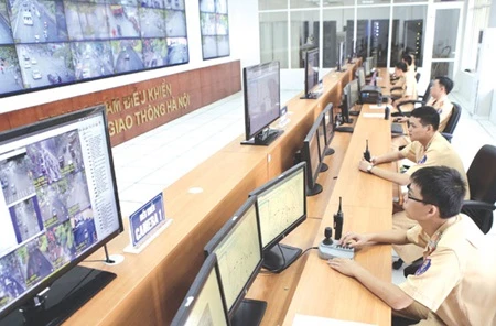Traffic police operate at the Hanoi Centre for Traffic Signal Control, a new project on IT advancement (Photo: VNA)