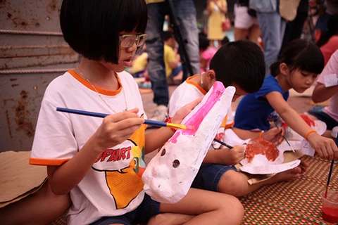 Interesados niños en elaborar máscaras para Festival del Medio Otoño