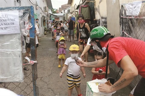 Un volontaire Français distribue des paniers-repas aux plus démunis