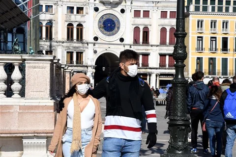 Туристы носят маски для защиты от COVID-19 при посещении площади Сан-Марко в Венеции, Италия, 24 февраля 2020 года. (Фото: Синьхуа /ВИА)