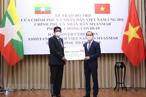 Заместитель министра иностранных дел Нгуен Куок Зунг вручил вручил финансовую помощь в размере 50.000 долларов США послу Мьянмы во Вьетнаме Кьяу Со Вину. (Фото: ВИА)
