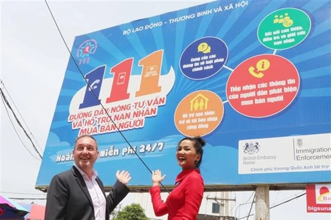 Заместитель главы миссии при посольстве Великобритании Стивен Лизах (слева) и Мисс Вселенная Вьетнам 2017 Хэн Не стоят перед рекламным щитом (Фото: ВИА)