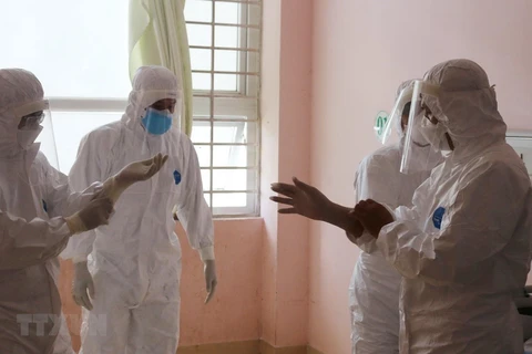 Группа быстрого реагирования больницы Чорай помогает медицинскому персоналу больницы Бариа одевать защитную одежду. (Фото: ВИА)