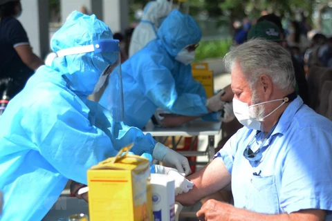 Медперсонал берет кровь у иностранцев для тестирования на SARS-CoV-2. (Фото: ВИА)