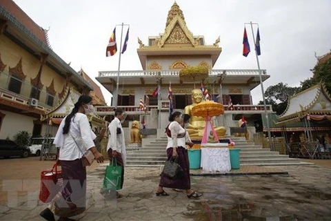 Камбоджийцы носят маски у пагоды (Фото: ВИА)