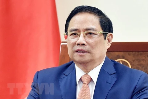 Премьер-министр Фам Минь Тьинь выступает на глобальном Саммите по торговле услугами 2021 года в виде видеозаписи. (Фото: Зыонг Жанг/ВИА)