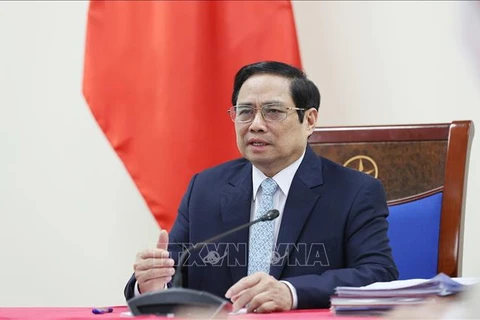 Премьер-министр Фам Минь Тьинь выступает на встрече. (Фото: Зыонг Жанг/ВИА)
