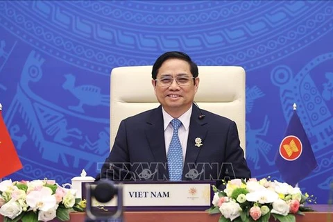 Премьер-министр Фам Минь Тьинь на 24-м онлайн-саммите АСЕАН + 3. (Фото: Зыонг Жанг/ВИА)
