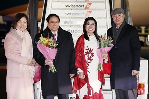Премьер-министра Фам Минь Тьиня с супругой (в центре) встречают в аэропорту Цюриха утром 16 января. (Фото: ВИA)
