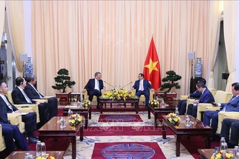 Премьер-министр Фам Минь Тьинь (справа) принимает министра коммерции Китая Ван Вэньтао. (Фото: ВИA)