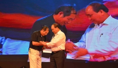 阮春福副总理向广宁省蒙阳煤炭公司代表赠送捐款（图源：越南《人民报》）