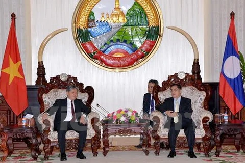 越南司法部长何雄强​与老挝政府总理通辛·坦马冯​ （图片来源：越通社）