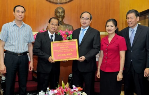 老挝驻越大使馆公使冯玛希萨纳代表老挝国家与人民向越方移交25.7万美元援助资金