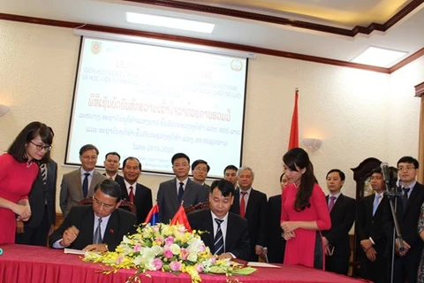 越南司法部下属司法学院与老挝司法部下属国家司法学院2016-2020年阶段合作备忘录的签署仪式。