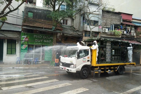 组图：河内市在发现新冠肺炎确诊病例的小区喷洒消毒剂