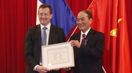前顺化市对外合作处处长阮然（右）荣获法国政府的学术界棕榈叶勋章