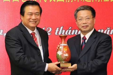 越南隆安省委书记、省人民议会主席范文让向百色市委书记、市人大常委会主任彭晓春赠送纪念品。