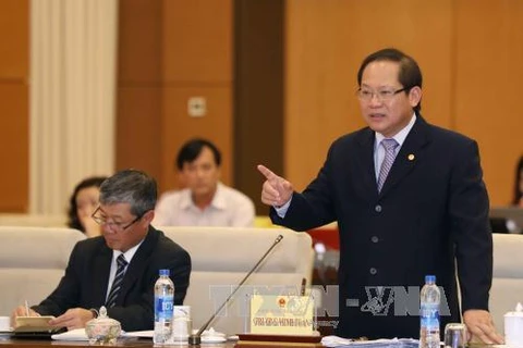 越南信息与传媒部部长张明俊回答国会代表的质询。（图片来源：越通社）