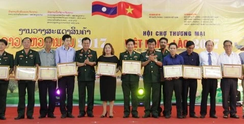 越南国防部代表向双方各企业和单位授予越南国防部奖状。（图片来源：越南人民报）
