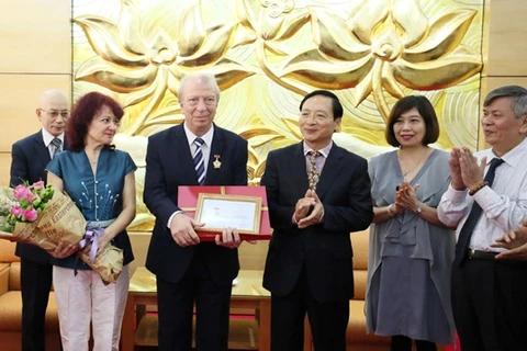 越南友好组织联合会副主席裴克山向保加利亚驻越南大使叶夫根尼• 斯托伊切夫授予“致力于各民族和平与友谊”纪念章。