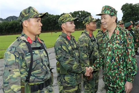 越共中央政治局委员、国家主席、国防安全理事会主席、越南武装力量统领人陈大光与干部战士们。